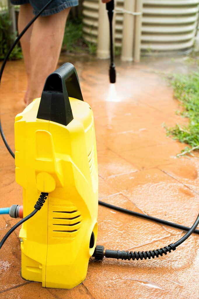 Cleaning backyard with pressure washer clelaner. Spring clean up